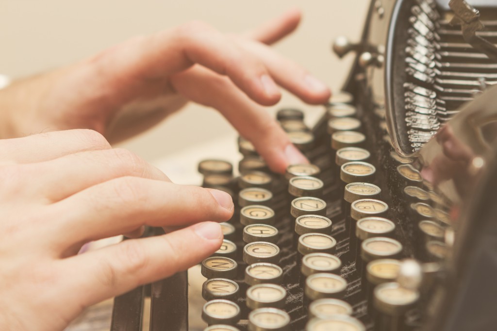 hands on an old typewriter