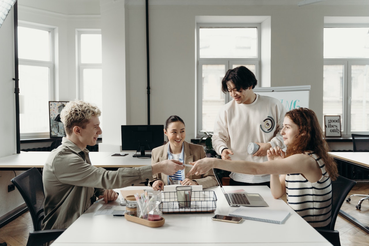 group of employees sitting in front of a table