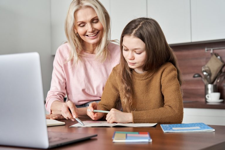 mother helping daughter in e-learning class